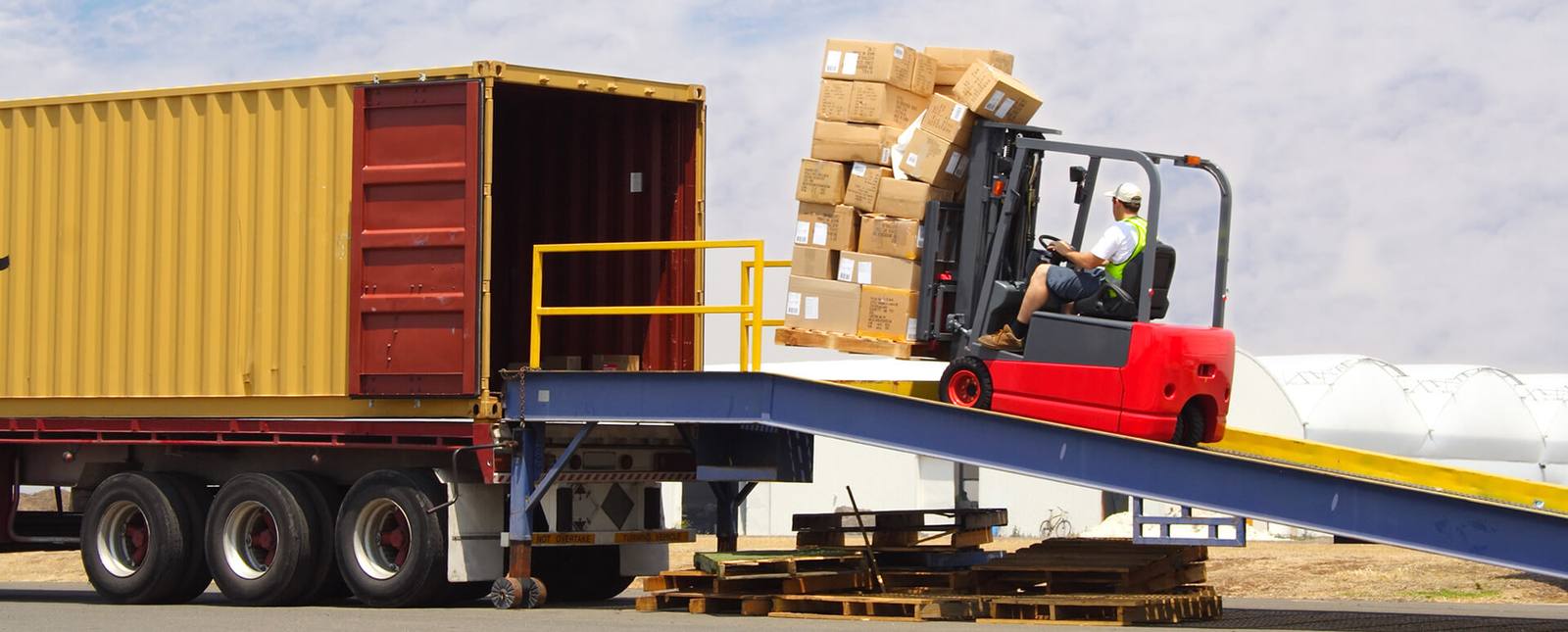 Shipping container being transported on a flatbed truck